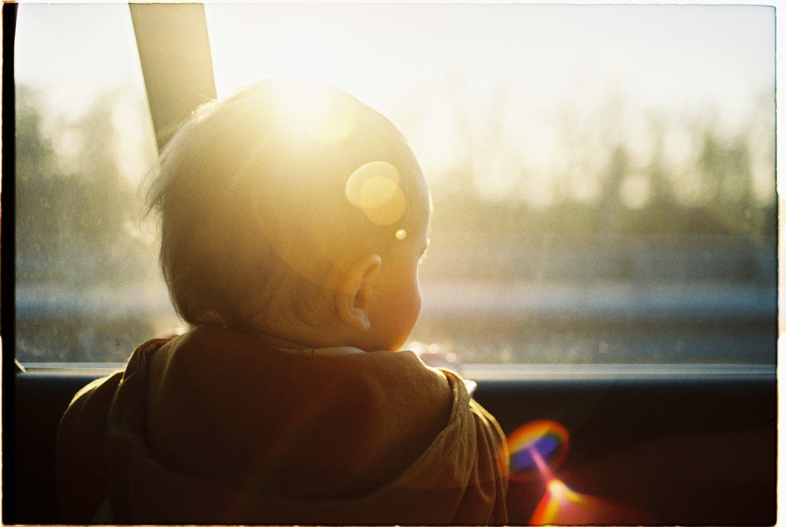 A baby looking through the window